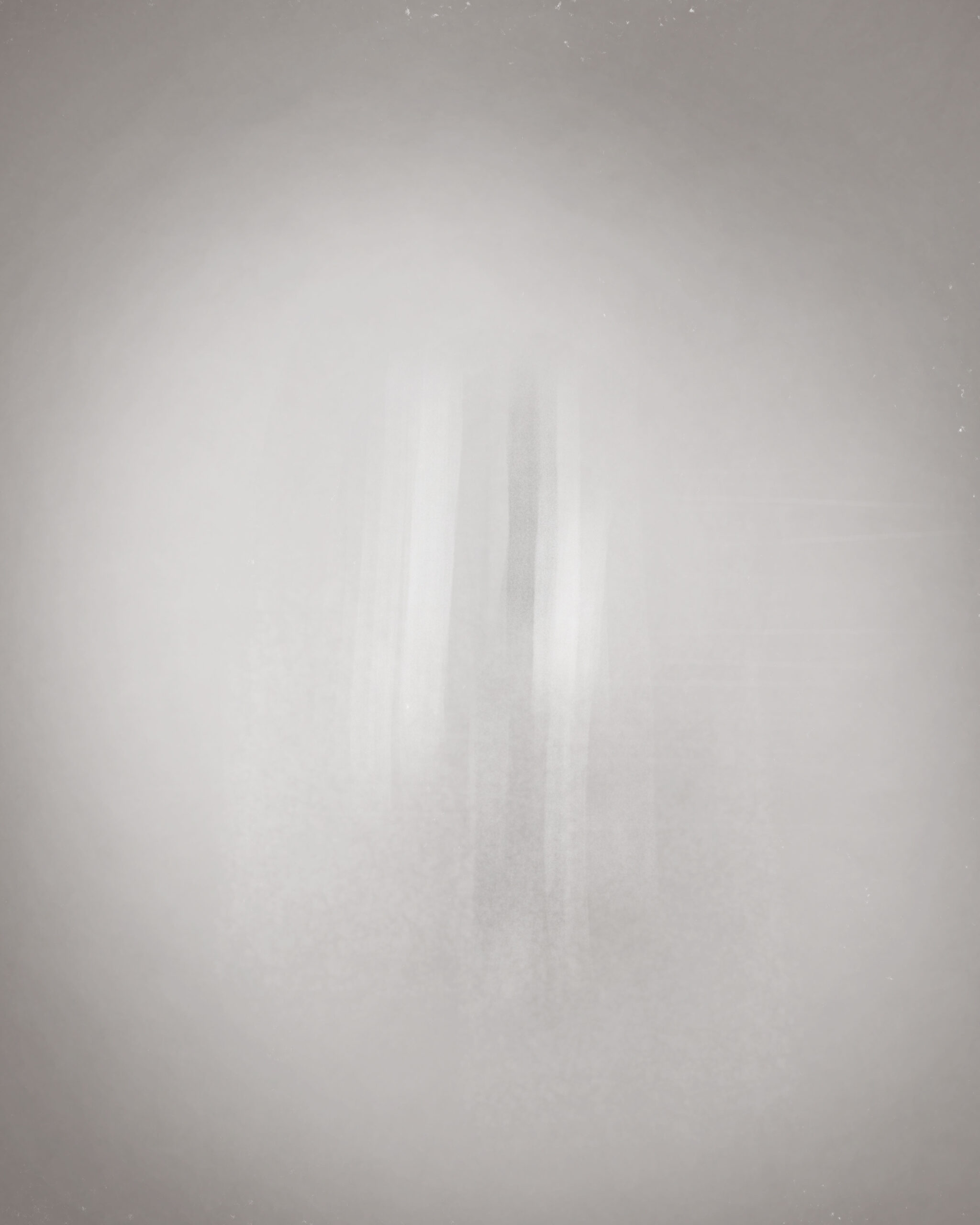 Still image from the animation Compression Field by Denis Leclerc, showing a subtle vertical blur emerging from a soft grayscale background. Part of the Liminal Drift series.